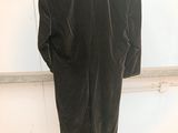 an image of a black velvet jacket hanging on a hanger