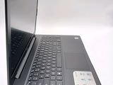 a black laptop computer sitting on top of a white table
