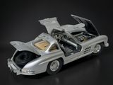a silver model of a car with its open hood open
