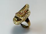 an image of a gold and diamond ring on a white surface
