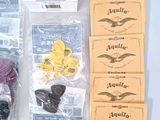 several guitar strings and strings in cello bags on a table