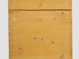 an old wooden box with a decorative design on top of it