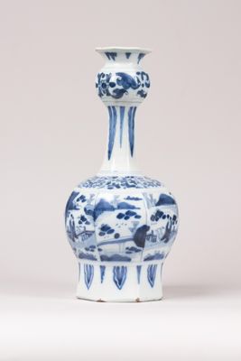 a blue and white vase sitting on a white surface