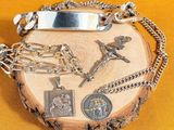 a silver plate with a cross and other religious items on it