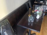 a long table with two chairs and a bag on it