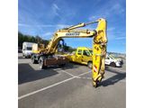 a picture of a yellow truck with a crane on it ' s back