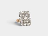 a close up of a diamond ring on a white surface