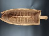 a small wicker boat that is sitting on a table