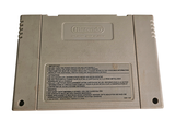 an old nintendo game console sitting on a white surface