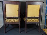 two chairs that are next to each other in a room