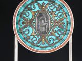 a close up of a blue and gold plate with a picture on it