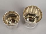 pair of silverplated cups on a white surface