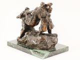 statue of a man and a woman on a rock with a dog