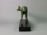 bronze statue of a deer on a black marble base