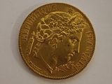 a close up of a gold coin on a white surface