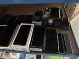 many cell phones on a table in a store