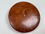 a wooden clock on the wall with a white background