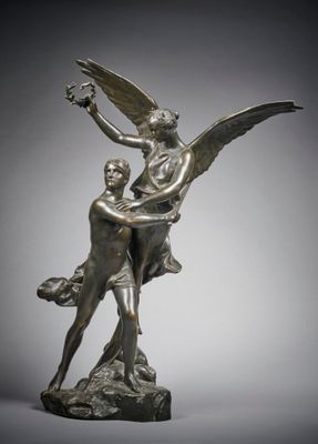 a bronze statue of a man and a woman on a rock