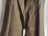 the jacket is hanging on a hanger on a white curtain