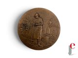 a bronze medal with a man and a woman on it