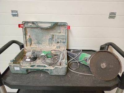 une vieille boîte à outils posée sur une table à côté d'une mallette à outils