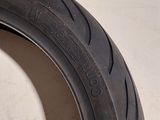 a close up of a motorcycle tire on a white surface