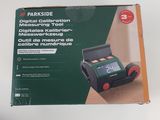 the box of a digital calibrator is open on the table
