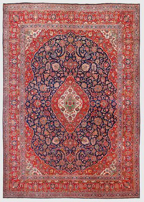 a red and blue rug with a medallion design on it