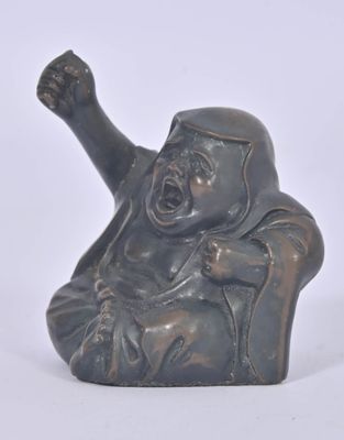 a statue of a man sitting on a chair with his arms up
