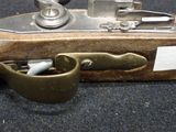 a metal object that is sitting on top of a piece of wood