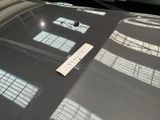 a sticker on the hood of a car that is parked in a parking lot