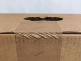 a brown box with a piece of paper taped around it
