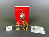 two small toy figurines are sitting next to a red box