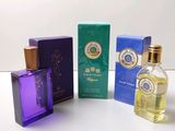 four bottles of perfume sitting next to each other on a table
