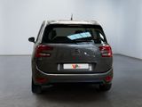 grey citrole parked in a white room with a black floor