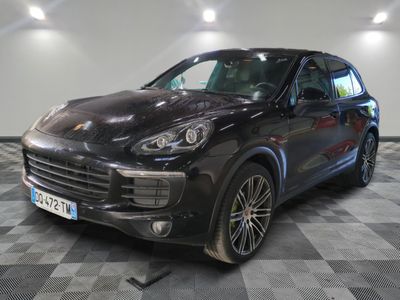La Porsche Cayenne noire est garée sur un sol à damier.