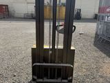 a close up of a forklift sitting on top of a wooden pallet