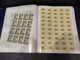 a close up of a book with stamps in it on a table