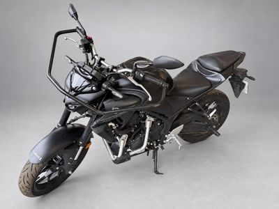 the black motorcycle is parked in a studio with a gray background