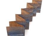 several pieces of wood are arranged in a row on a white surface