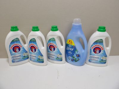 four bottles of laundry deter sitting on top of a white counter