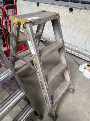 two ladders sitting next to each other in a garage