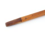 an old baseball bat with a wooden handle sitting on a white surface