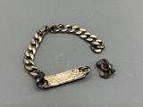 a close up of a metal bracelet with a chain and a clasp