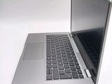 a silver laptop computer sitting on top of a white table
