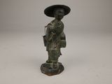 chinese bronze figurine of a woman with a hat and carrying a basket