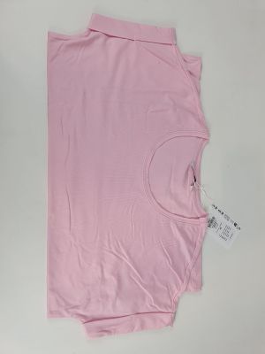 pink t - shirt on a white surface with a tag on it
