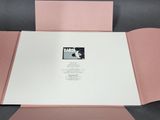 a close up of a pink folder with a picture of a man on it
