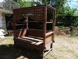 a wooden bed that is sitting in the grass