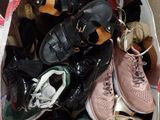 many pairs of shoes in a bag on the floor